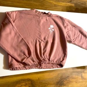 Rose colored sweatshirt that cinches at the bottom